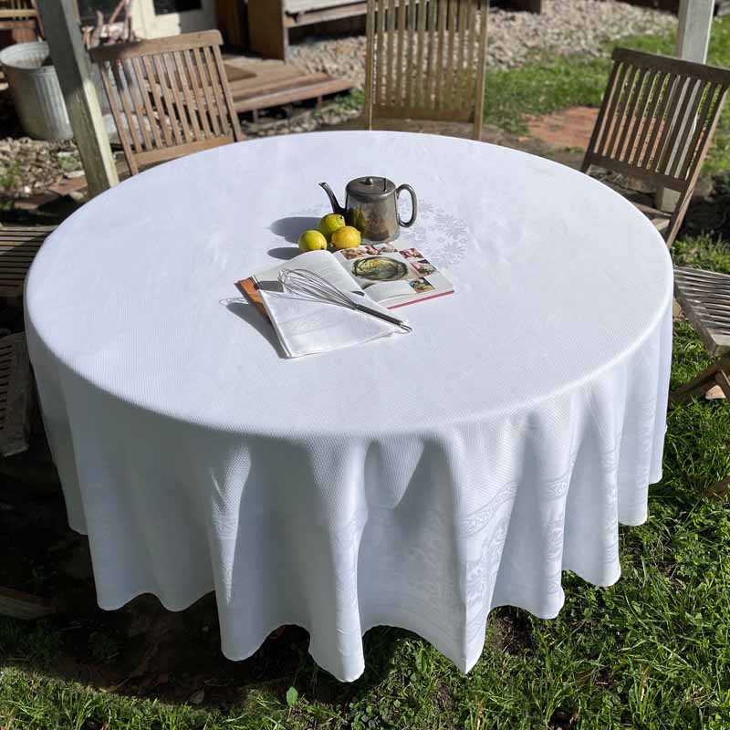 White jacquard round tablecloth in an outdoor setting