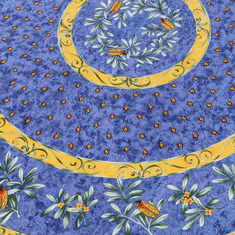 Decorative fabric pattern with blue background, yellow circles, green leaves, and orange insects.