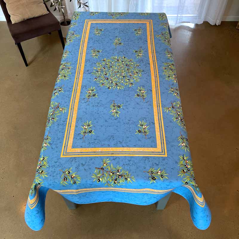 Blue tablecloth with floral patterns on a wooden table