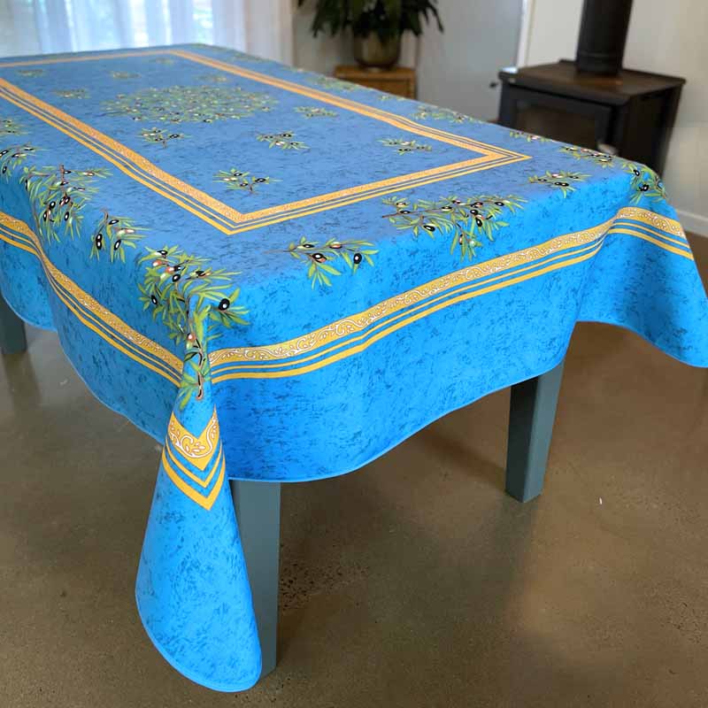 Blue tablecloth with green leaf pattern on a table