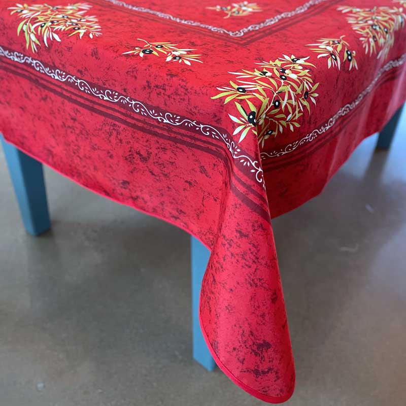 Red tablecloth with floral patterns on a blue chair