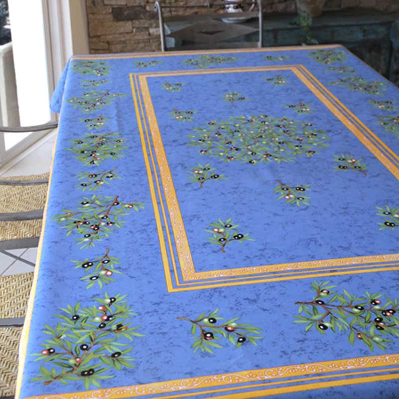 Blue tablecloth with olive pattern on a table outdoors