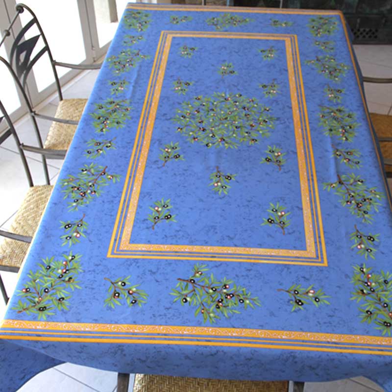 Blue tablecloth with olive pattern on a table