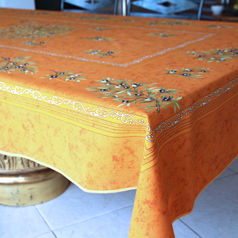 Orange tablecloth with olive pattern on a table