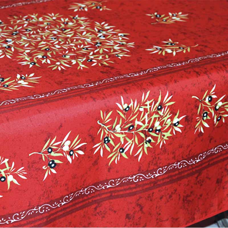Red tablecloth with olive design on a red background
