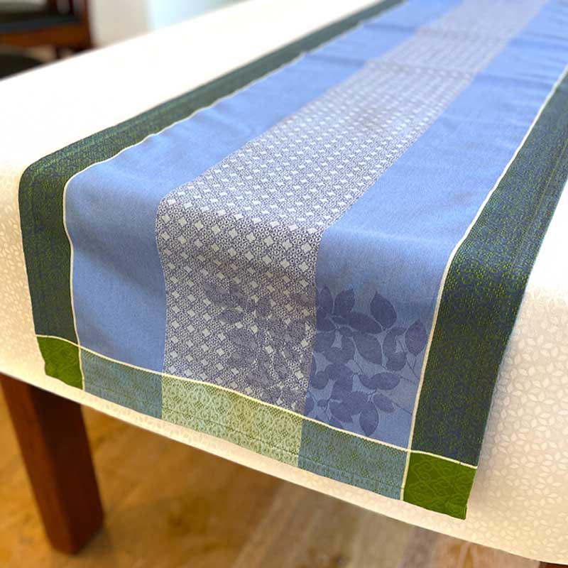 Table runner with blue and green pattern on a table