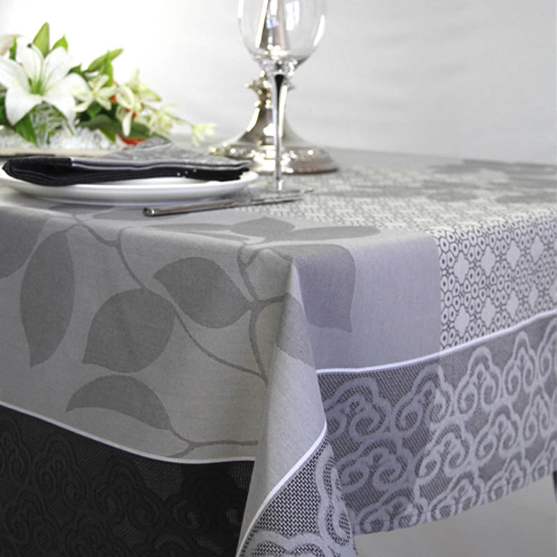 Tablecloth with leaf and lace patterns on a set dining table.