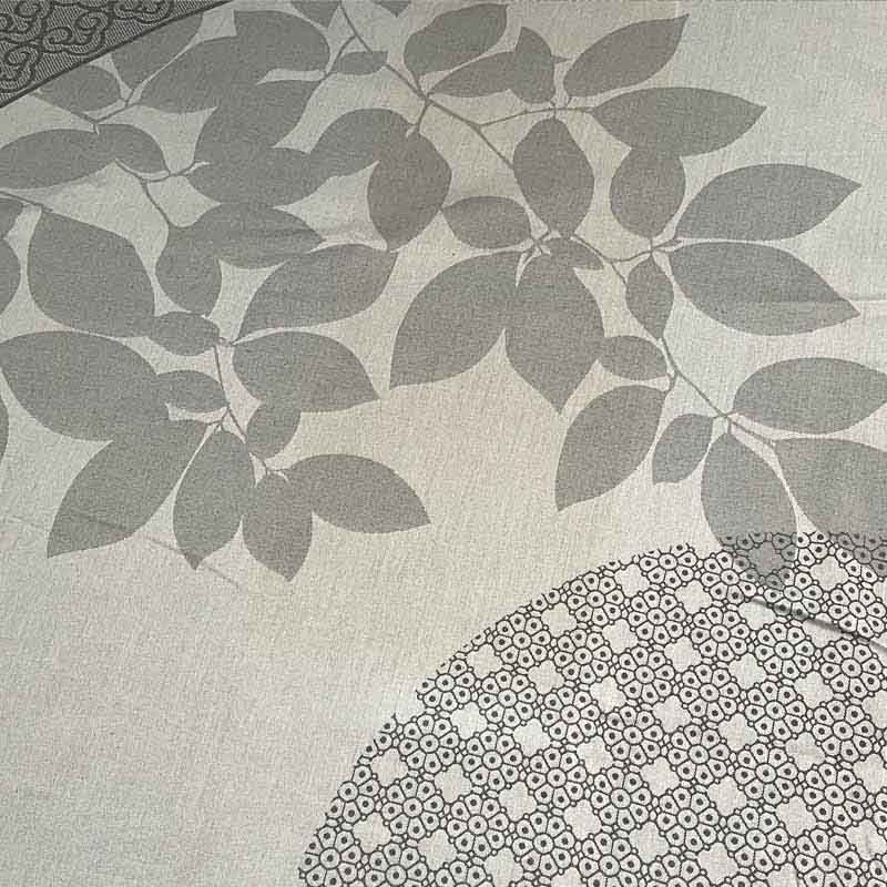 Closeup of uneven discolouration in the grey woven fabric of a Deauville Grey round jacquard tablecloth sold as seconds