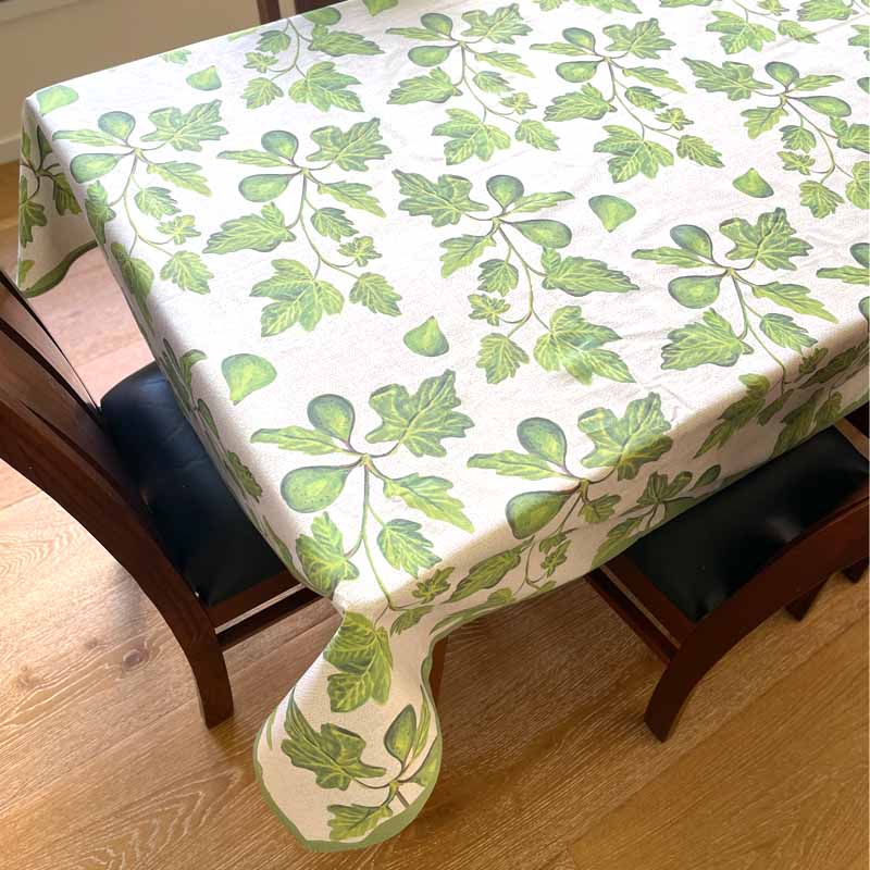 Tablecloth with green leaf pattern on a wooden table
