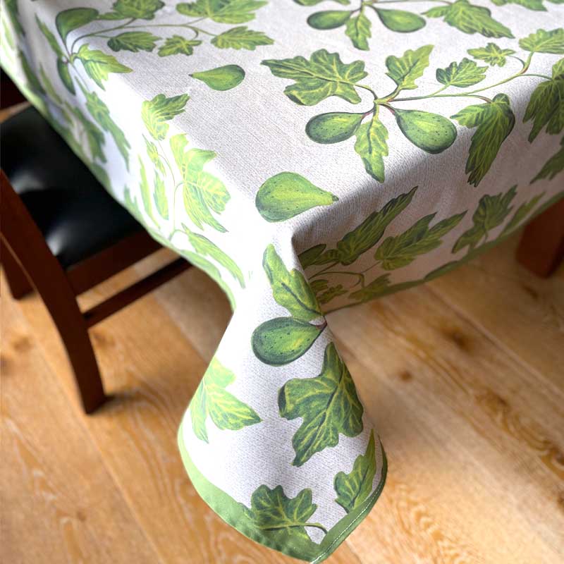 Green leaf patterned tablecloth on a wooden table