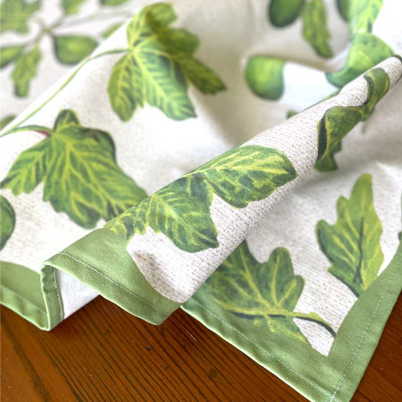 Green leaf-patterned fabric on a wooden surface