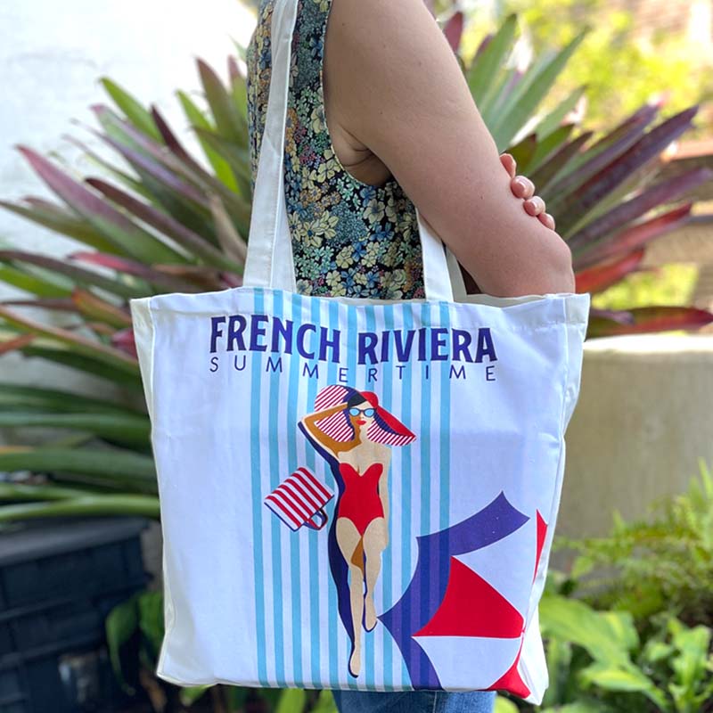 French Riviera Summertime cotton tote bag shown over the shoulder