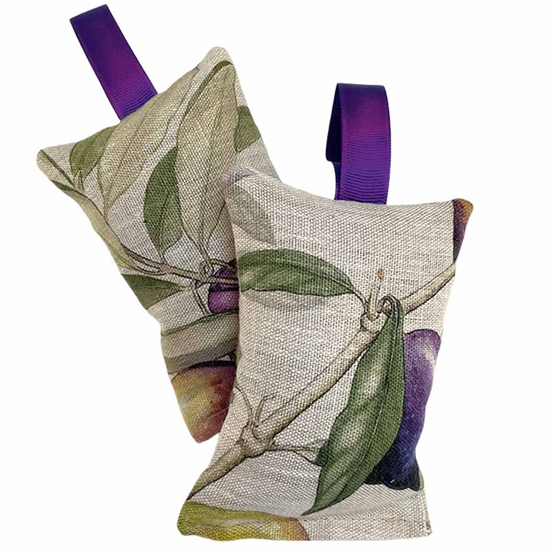 Two rectangular lavendar sachets with purple hanging loops, printed with green leaves and purple fruit on a light beige woven background, shown on a white background.