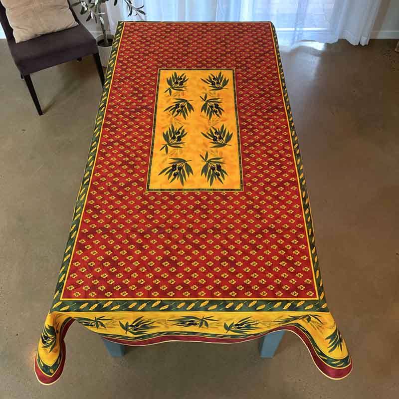 Decorative tablecloth with a red and yellow pattern on a table