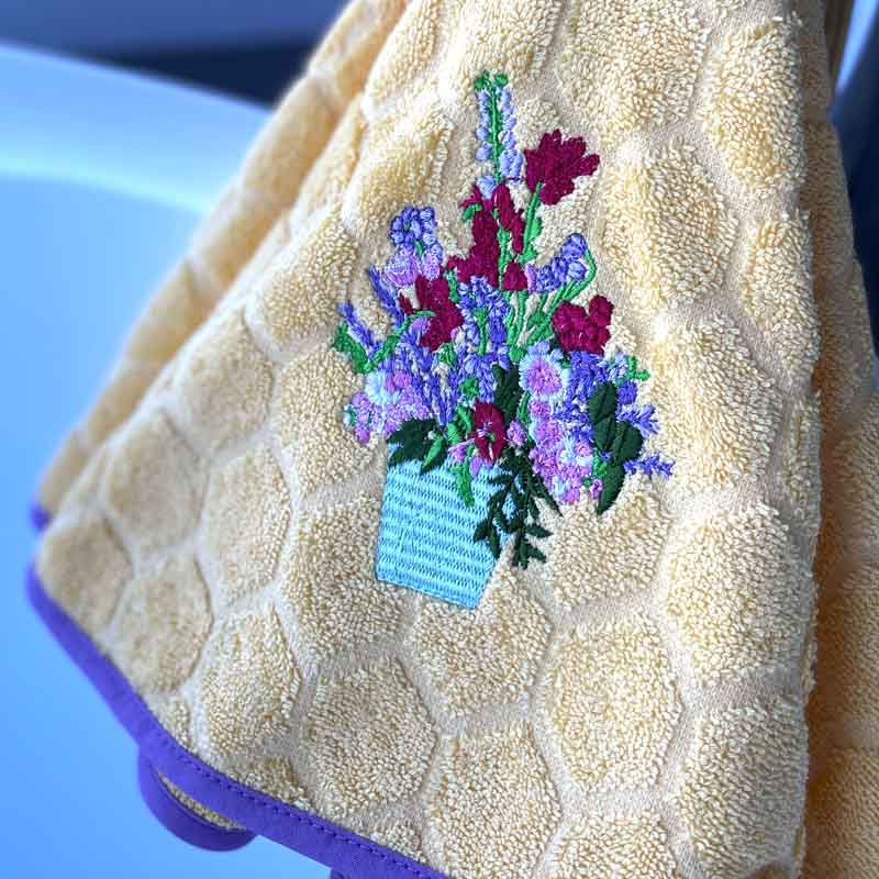 Yellow hanging towel with embroidered flowers