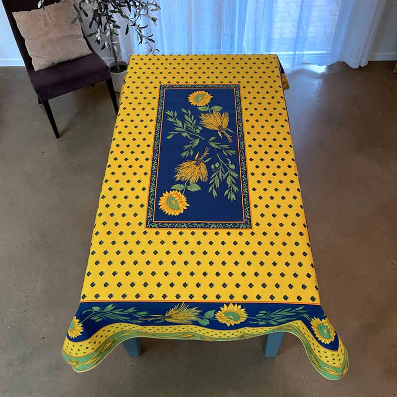 Yellow tablecloth with blue floral design on a rectangular table