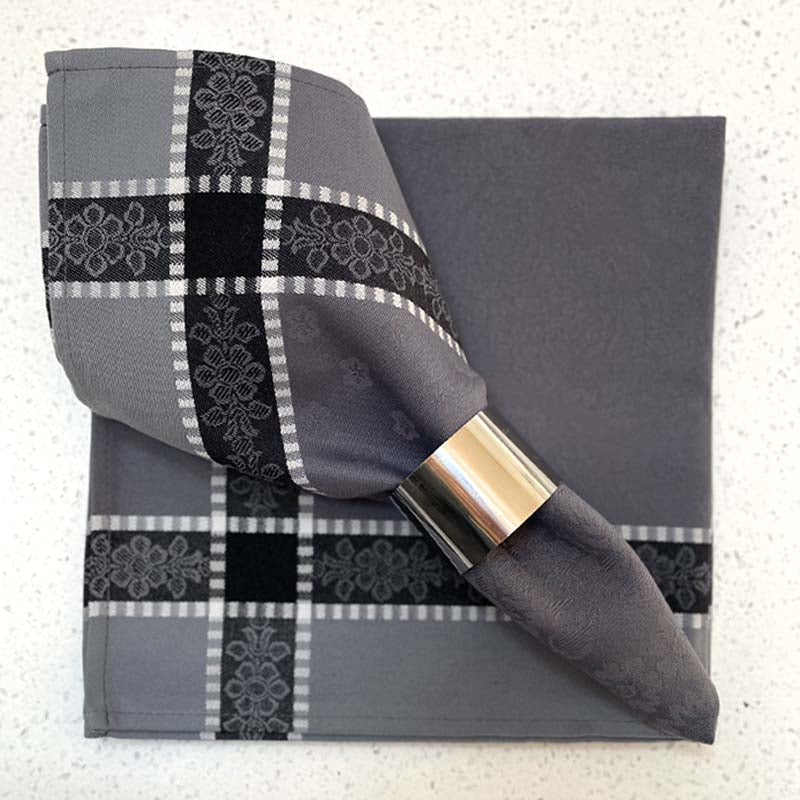 Gray napkin with black and white pattern on a textured surface
