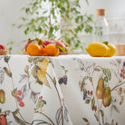 Fruits design tablecloth with fruits on top of table