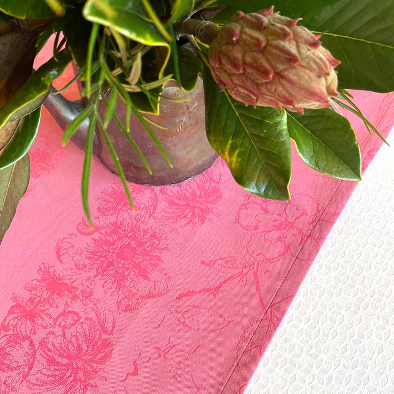 Pink floral-patterned fabric with a plant on top