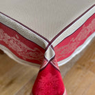 Red and beige patterned tablecloth on a wooden surface