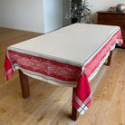 Tablecloth with red and beige pattern on a wooden table