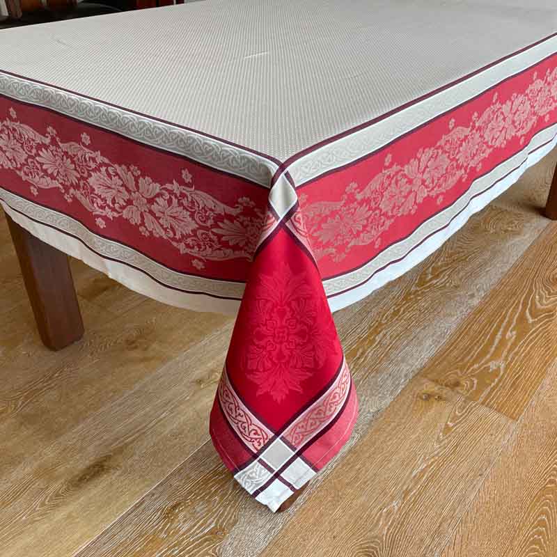 Red and fawn patterned tablecloth on a wooden table