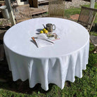 White jacquard round tablecloth in an outdoor setting