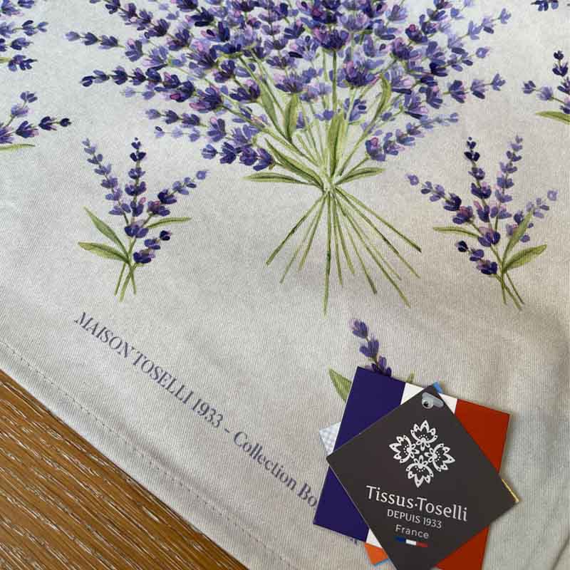 Close up of tags for French stain resistant tablecloth with lavender bunches