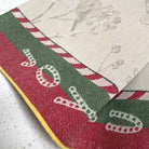 The border of a Christmas tea towel showing the jacquard weave.