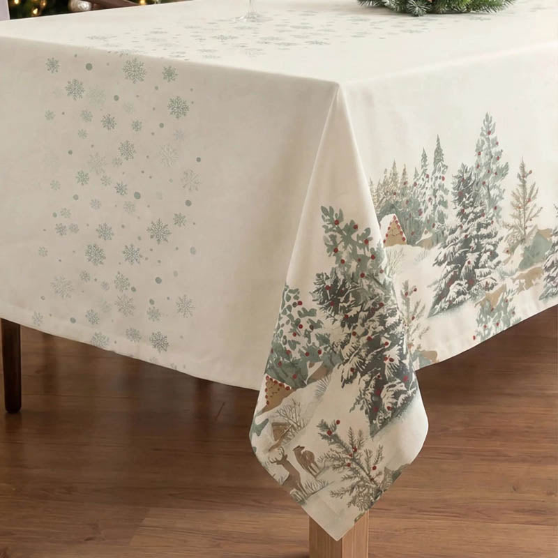 Corner of a Christmas tablecloth with fir trees and deer design on the side borders.