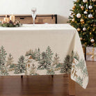 Christmas tablecloth with fir trees and deer design on the side borders.