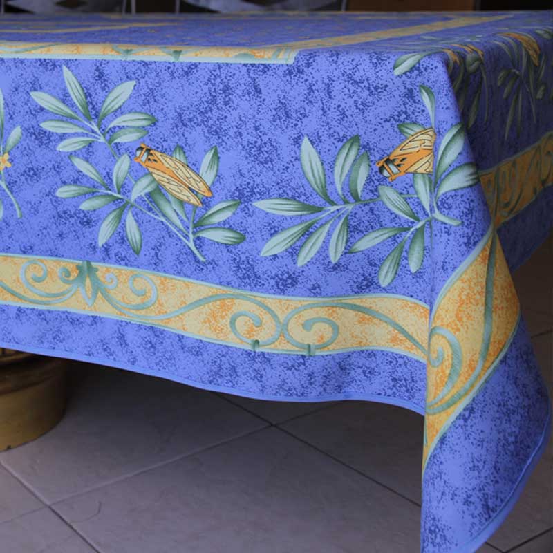 Blue tablecloth with floral patterns on a tiled floor background
