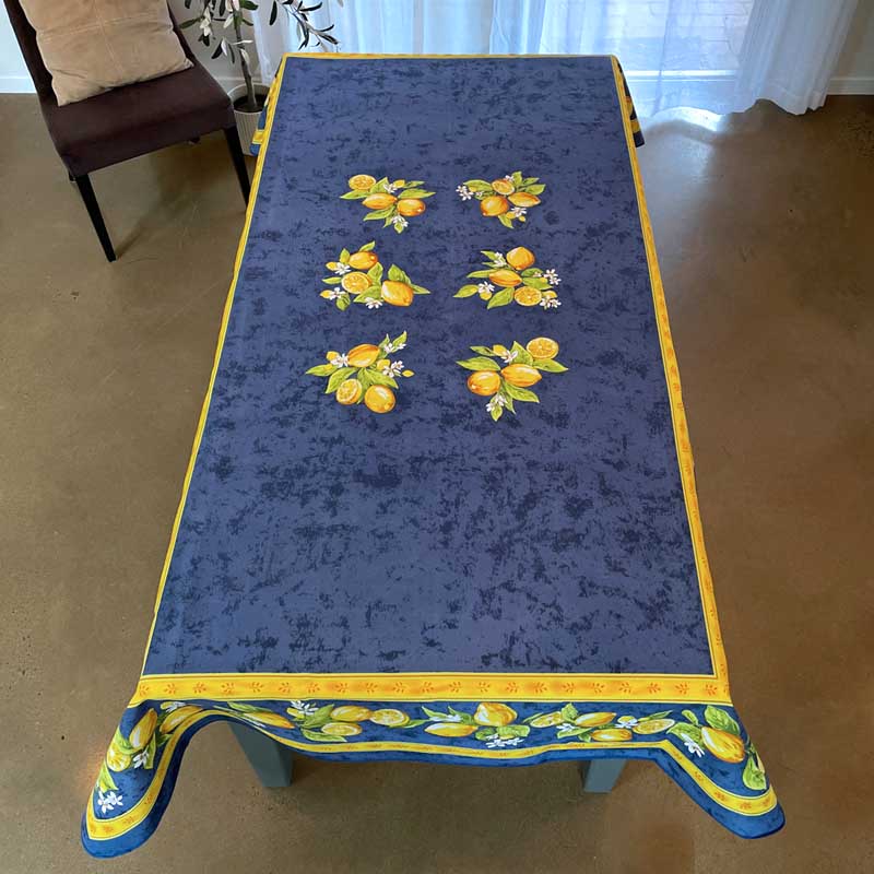 Decorative tablecloth with lemon pattern on a wooden table