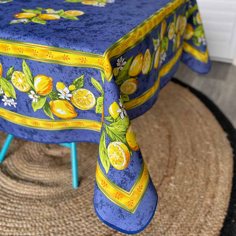 Corner of Citron tablecloth showing lemons on a blue background with yellow border.