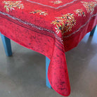 Red tablecloth with floral patterns on a blue chair