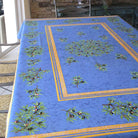 Blue tablecloth with olive pattern on a table outdoors