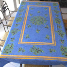 Blue tablecloth with olive pattern on a table