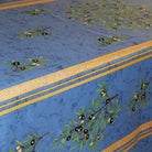 Decorative tablecloth with olive branch pattern on a blue background