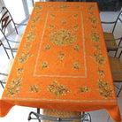 Orange tablecloth with olive pattern on a table