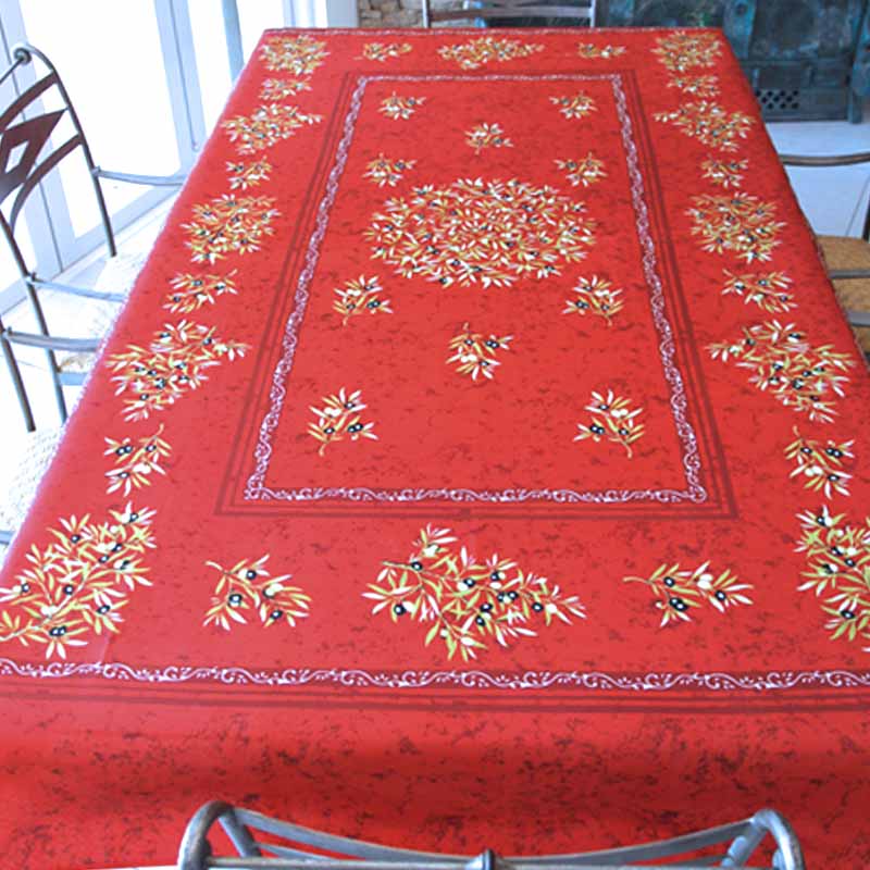 Red tablecloth with olive patterns on a table