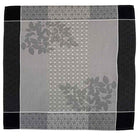 Gray patterned jacquard napkin with floral designs on a black border