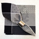 Napkin with a decorative metal clip on a textured white background