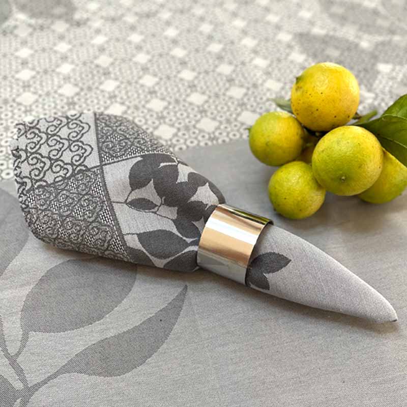 Grey jacquard napkin black, grey and white pattern on a gray tablecloth with lemons
