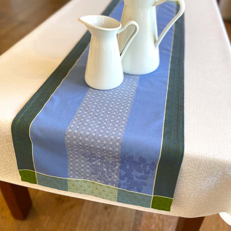 Tablecloth with blue and green pattern on a wooden table