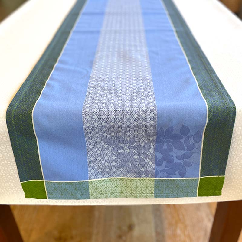 Table runner with blue and green pattern on a wooden table