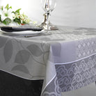 Tablecloth with leaf and lace patterns on a set dining table.