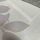 Example of discolouration on Deauville Grey jacquard tablecloth seconds, with uneven pale and brownish areas among the woven leaf pattern