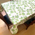 Tablecloth with green leaf pattern on a wooden table