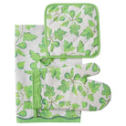 Set of green leaf-patterned oven mitt, pot holder, and towel on a white background