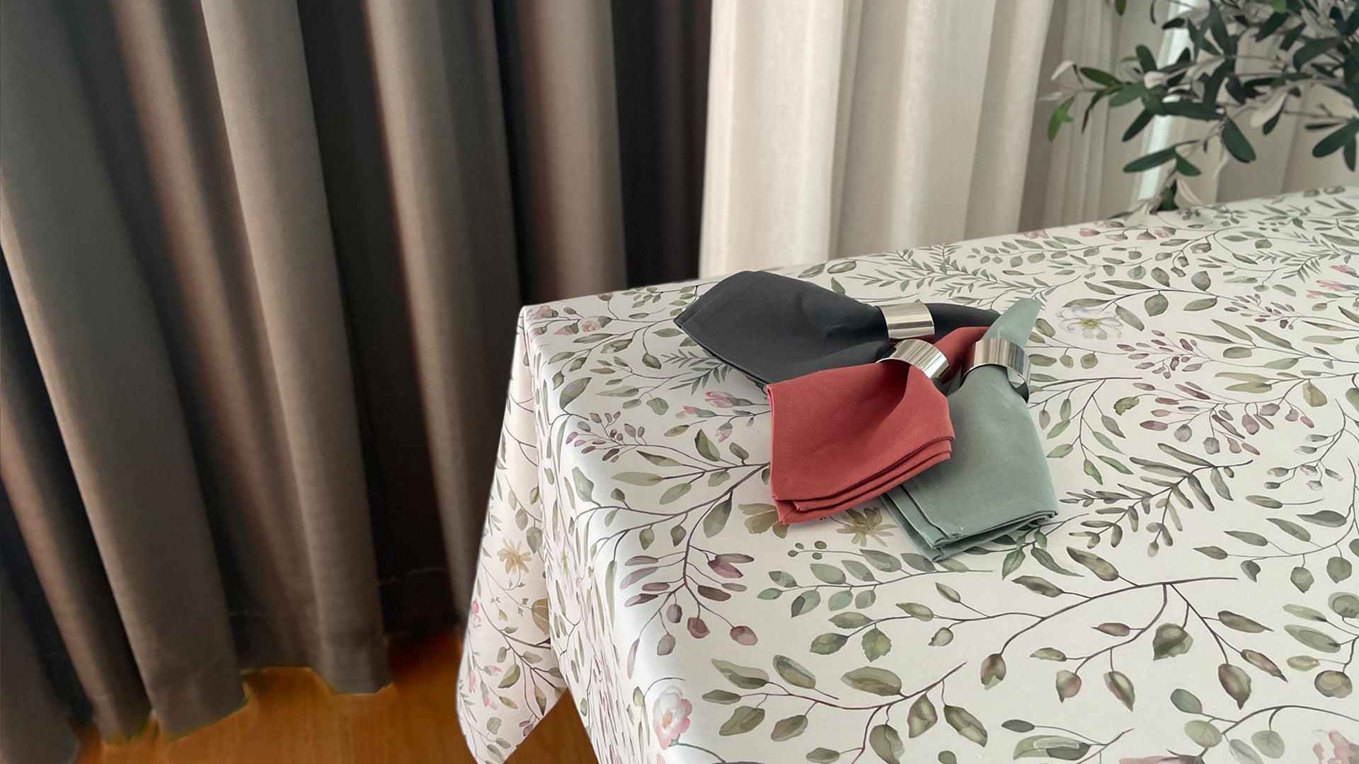 Elegant folded cloth napkins on a floral tablecloth